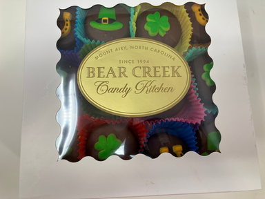Box of Bear Creek Candy Kitchen chocolates with colorful wrappers on a white background