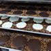 Bear Paws cooling on trays inside Bear Creek Candy Kitchen
