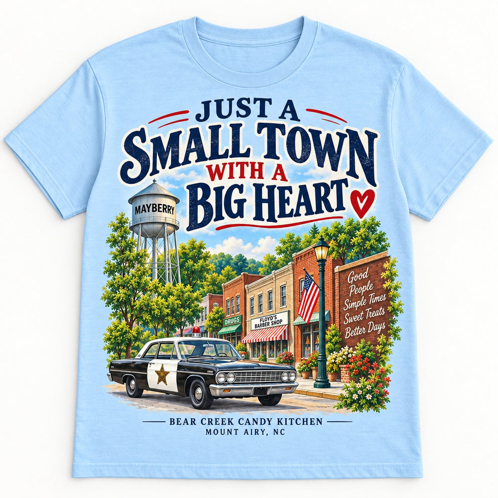 Temporary concept mockup: sky-blue Small Town with a Big Heart T-shirt with a Mayberry street scene.
